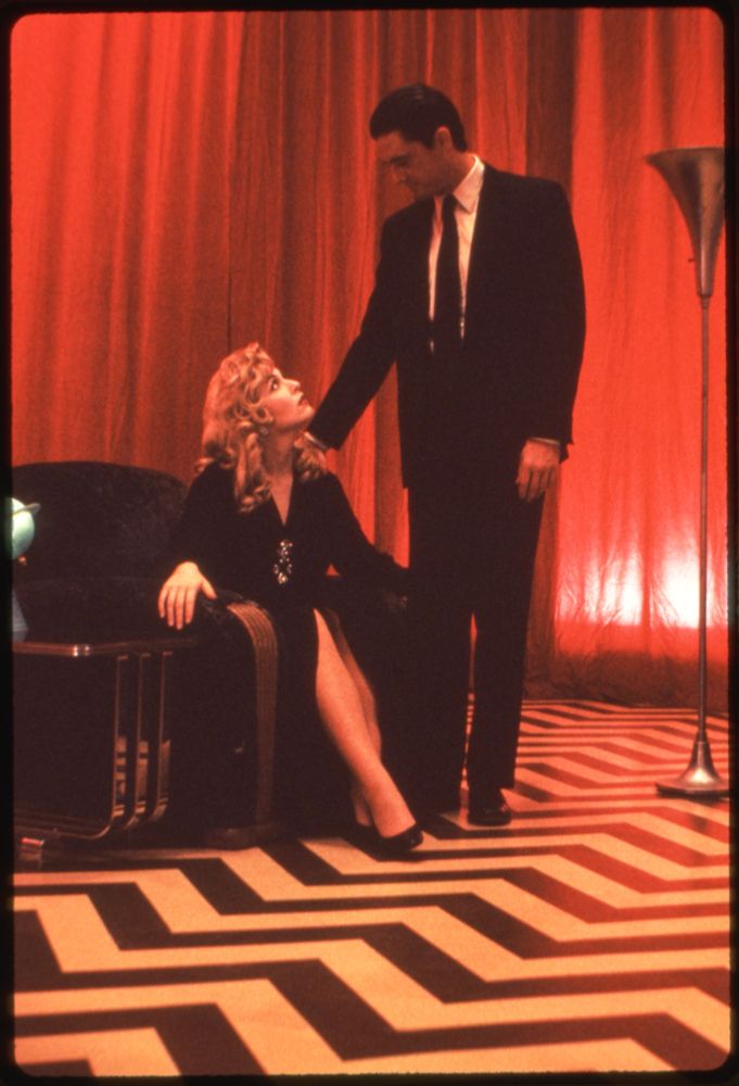 Laura Palmer sitting in a chair looking up at Dale Cooper in the Red Room