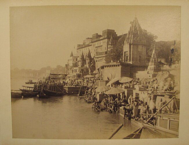 This photograph captures the bustling life along the ghats of Varanasi, India, where ornate temples and buildings line the Ganges River, reflecting the city's architectural and cultural vibrancy. Part of the Brooklyn Museum's Asian Art collection, it offers a glimpse into 19th-century Indian urban landscapes and spiritual practices.
