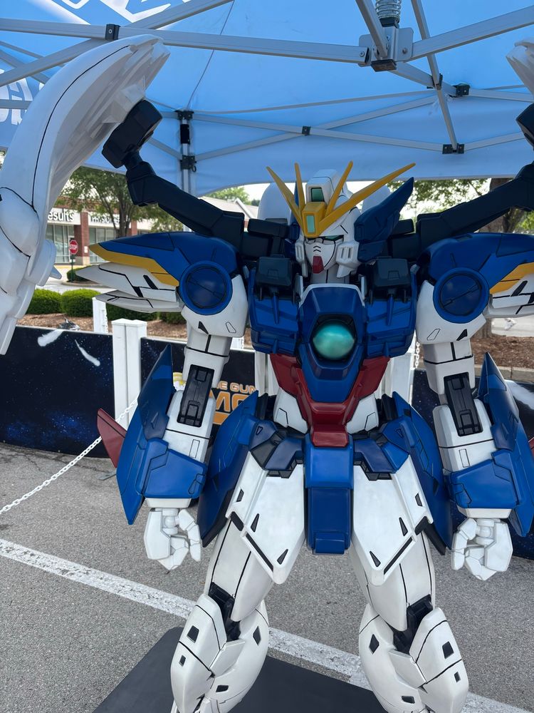 Photo of giant Gundam wing statue on parking lot