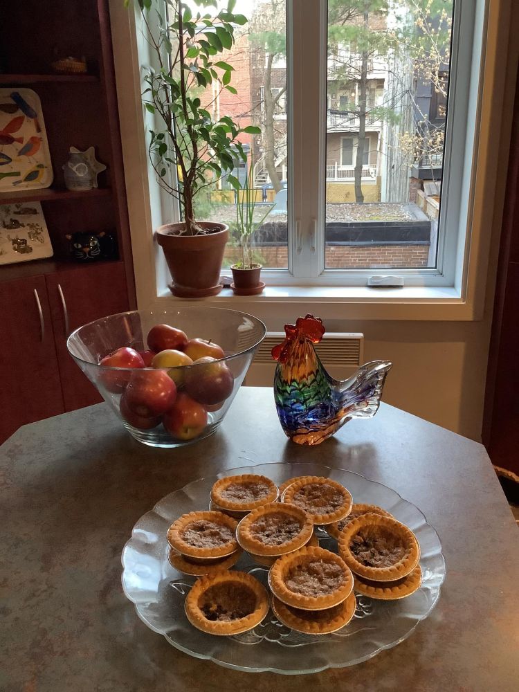 Photograph of butter tarts in my kitchen, watched over by a glass rooster 