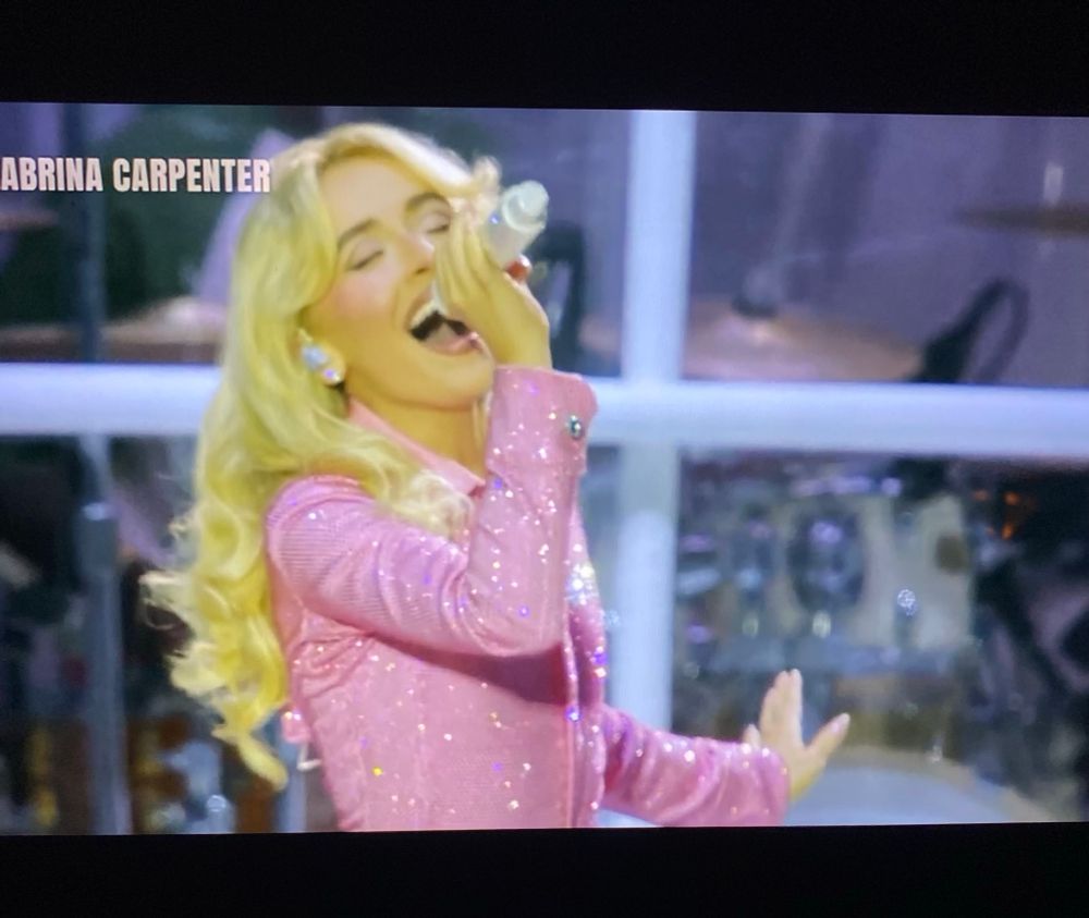 Sabrina performing at Lollapalooza in a pink jumpsuit 