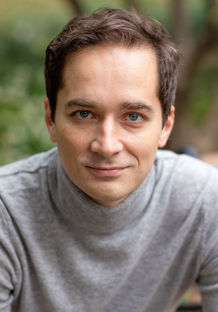 Portrait of neuroscientist Nikolay Kukushkin wearing a grey turtleneck