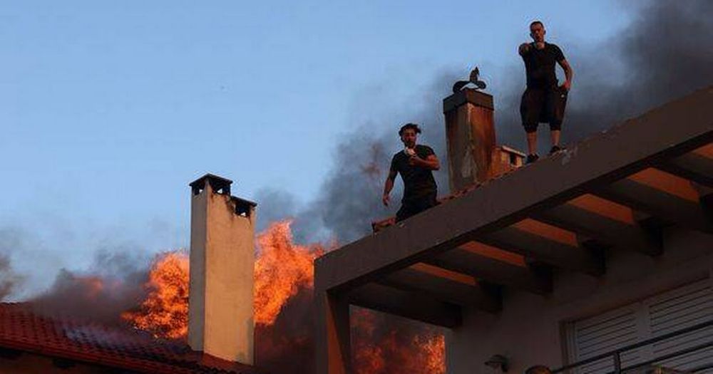 Tourists and locals flee Athens and islands as wildfires break out in Greece