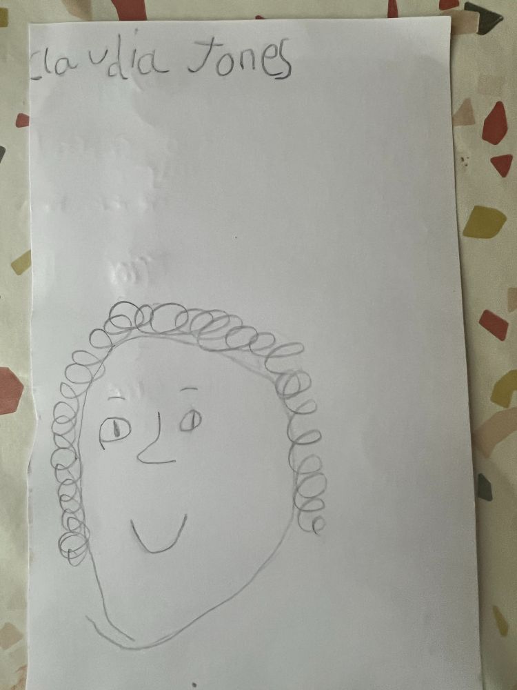 A pencil drawing by a child of a face with curly hair and the writing Claudia Jones above it.