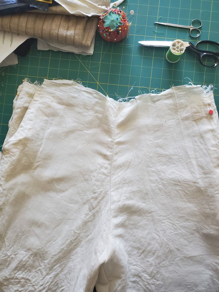 Trouser pleats removed.



