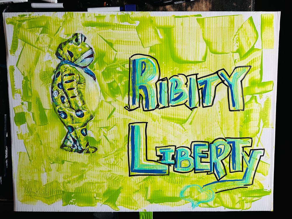 Painted Portland frog on a green background done with a palette knife, green and blue lettering that reads Ribbity Liberty