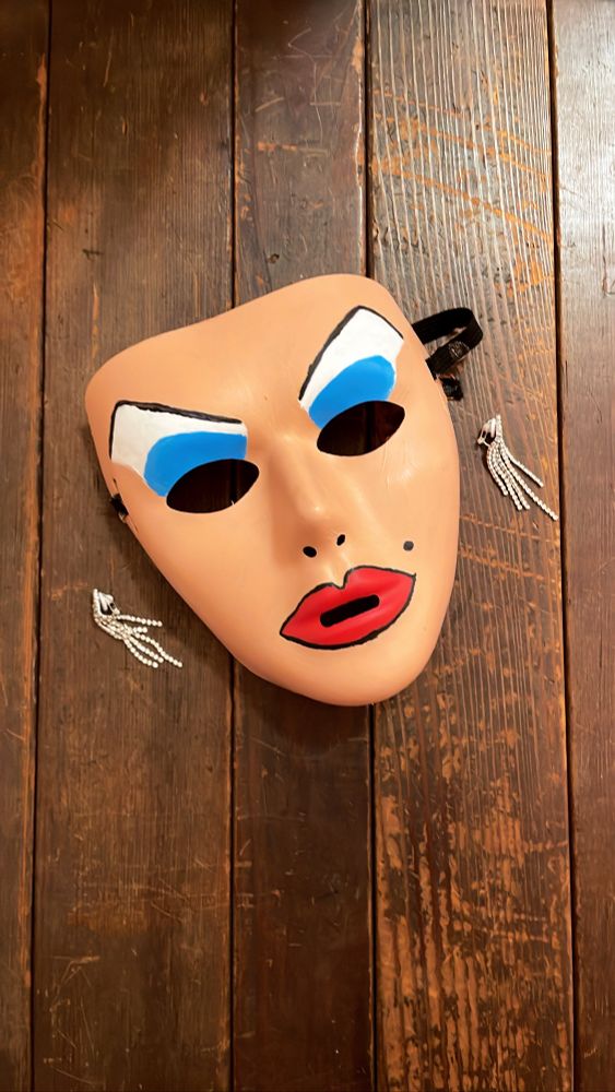 just the Divine mask and a pair of clip on dangly diamond earrings 