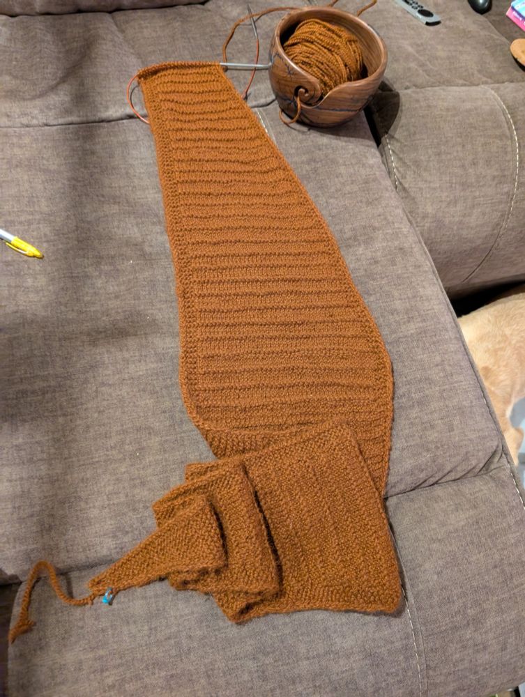 Knitted scarf in progress on a sofa. 