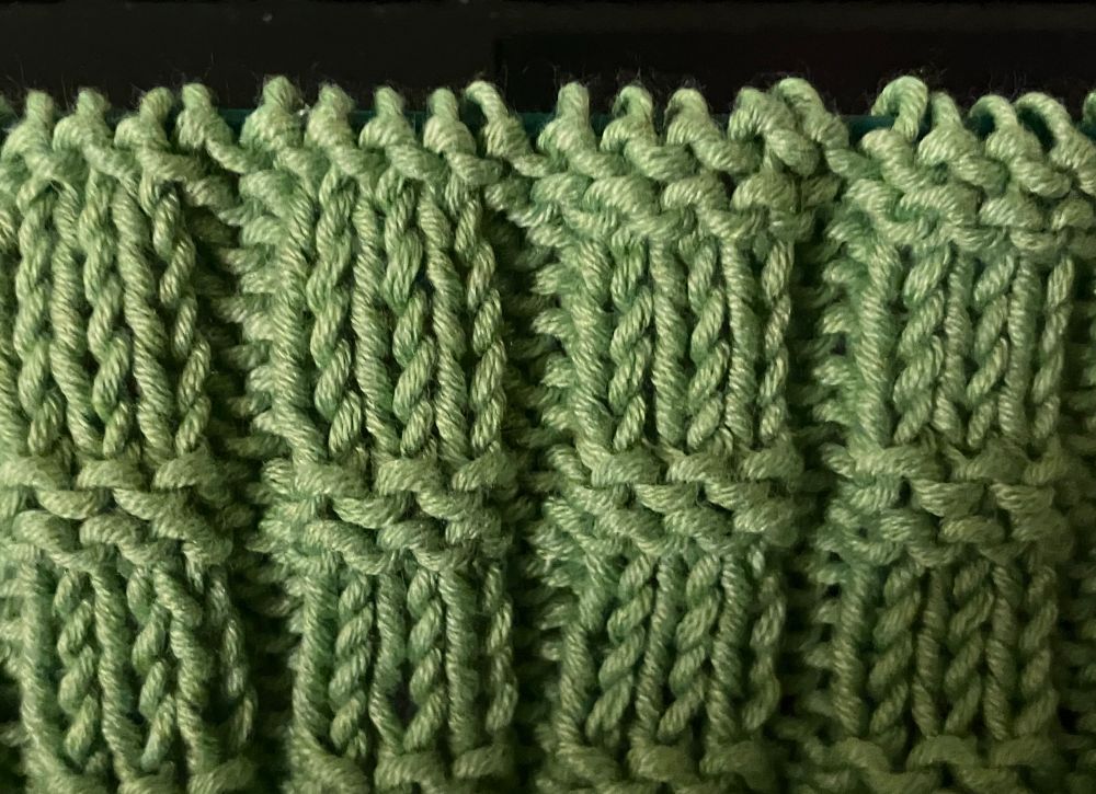 A section of knitting which shows that I forgot to carry on the purl row HALFWAY THROUGH A ROW, so now I have to pull back the two and half rows past my fuckup 