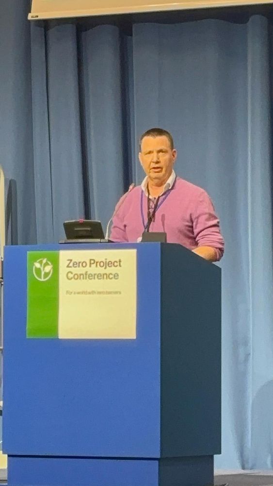 Jerry standing behind a podium at Zero Project Conference