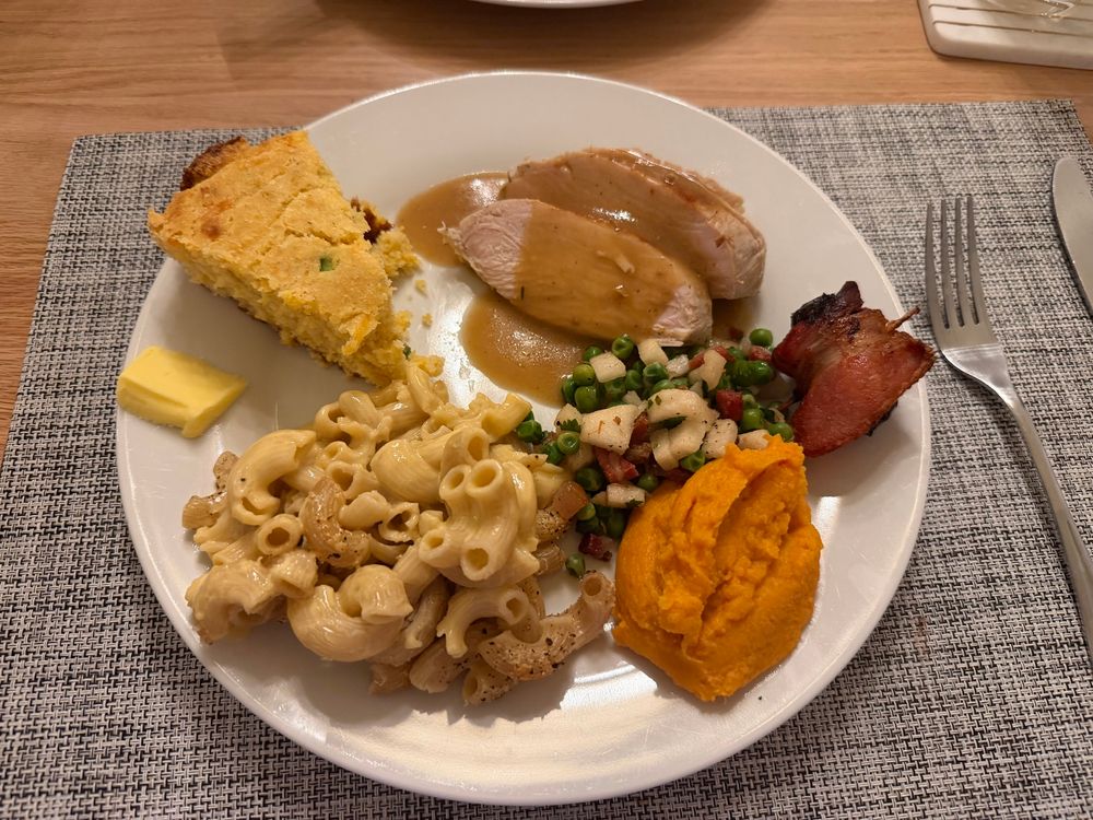 A plate of food containing all of the above mentioned items, plus turkey with gravy 