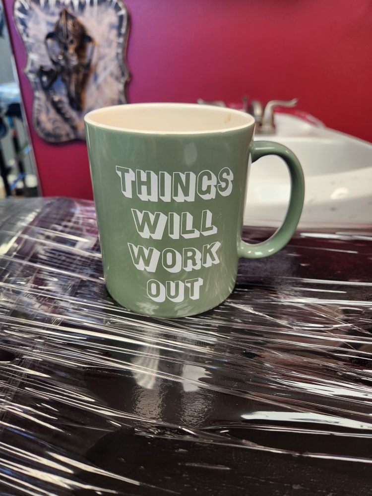 Sage colored mug with the words, "things will work out" on it.