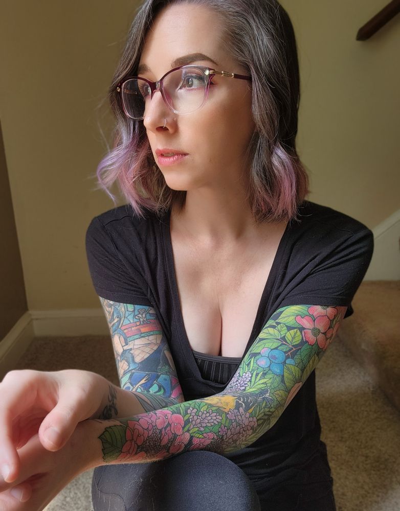 Photo of a woman with two tattoo sleeves 