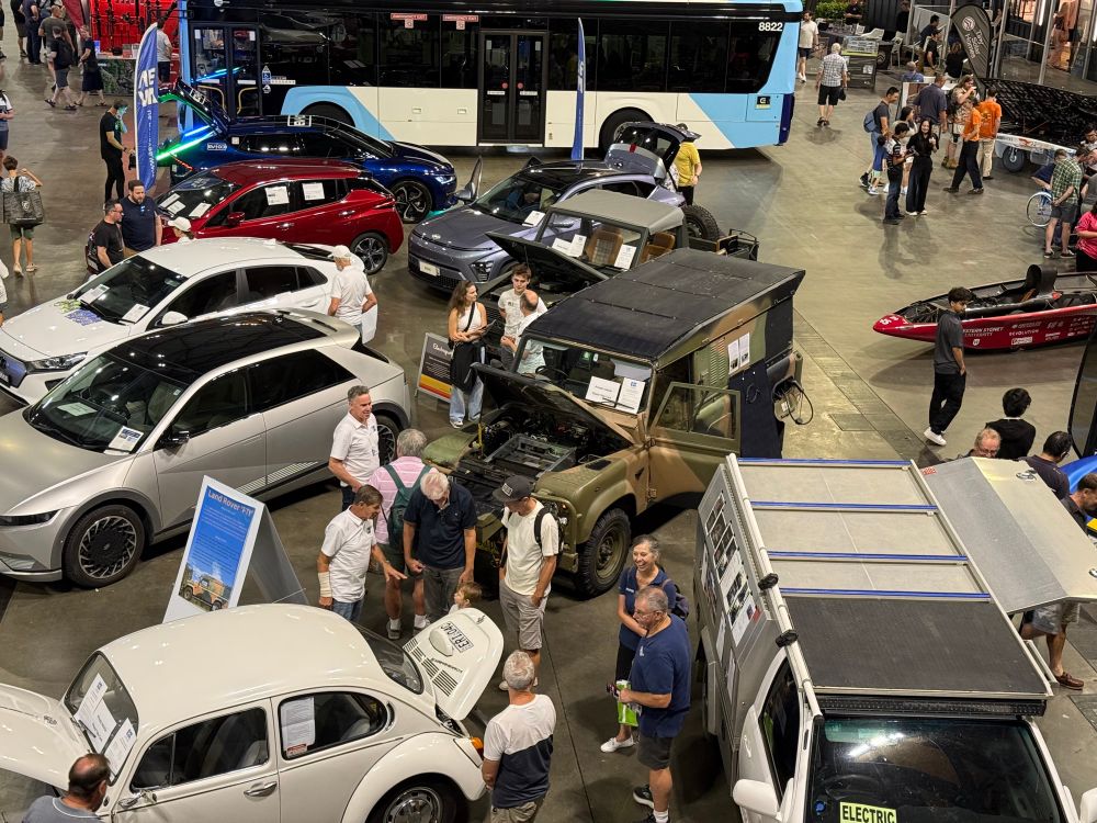 A Birds Eye view of the Australian electric Vehicle Association display at Everything Electric Australia with privately owned EVs including several converted 4x4s - a Toyota hilux, a landrover and a Mercedes, as well as a VW beetle. 