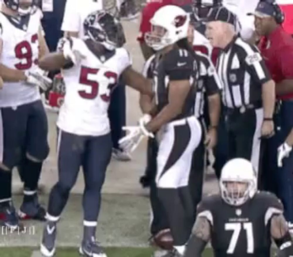 a football player with the number 71 on his jersey is talking to another player