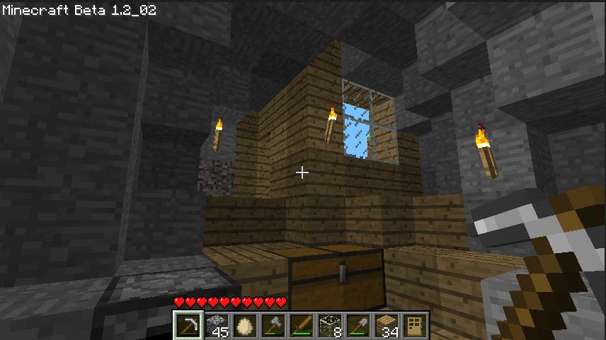 Moving inside the wood planks create a layer over the cave steps that leads into a floor with a chest and a furnace. 