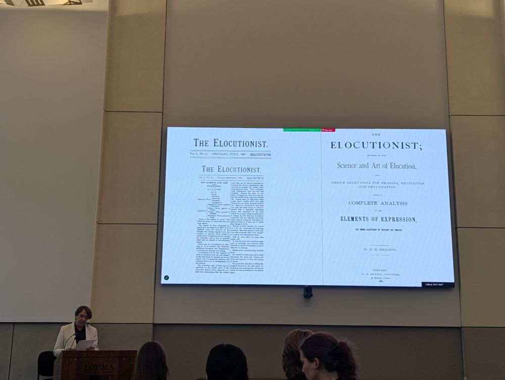 Prof Camlot stands in front of his PowerPoint, which features two pages of the 19thC Chicago periodical The Elecutionist.
