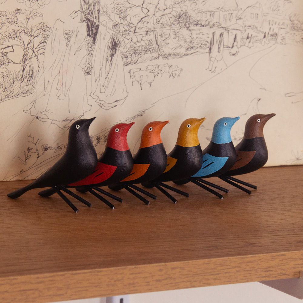 Hand painted wooden grackles in a rainbow of fall-inspired hues.
