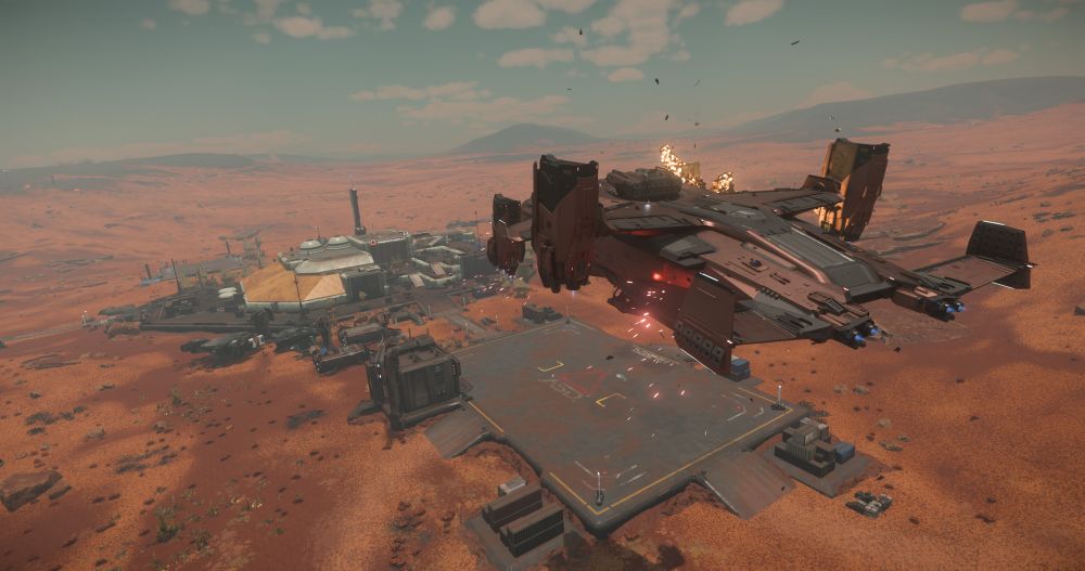 An engine explodes on a copper and black Anvil Asgard as it attempts to land under fire at a Farro Data Center on the planet Pyro 4 in the game "Star Citizen".