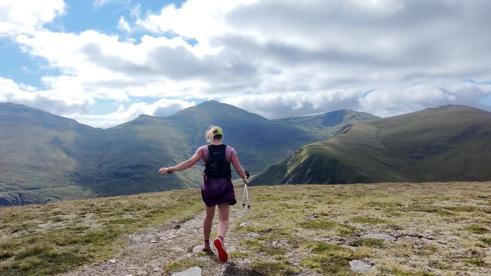 Me running off with mountains behind 