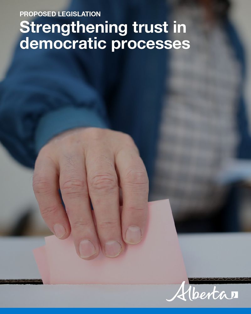 Images shows a person placing a paper ballot into a ballot box. Text reads, Proposed Legislation, Strengthening trust in democratic processes, with white Alberta logo.]