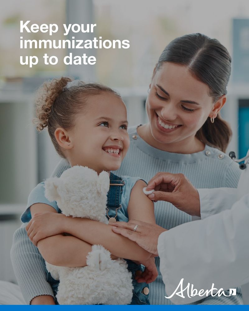 A health care worker is prepping a child's arm for an immunization. Parent and child are smiling. Text reads Keep your immunizations up to date. The Alberta government logo is in the bottom right corner. 