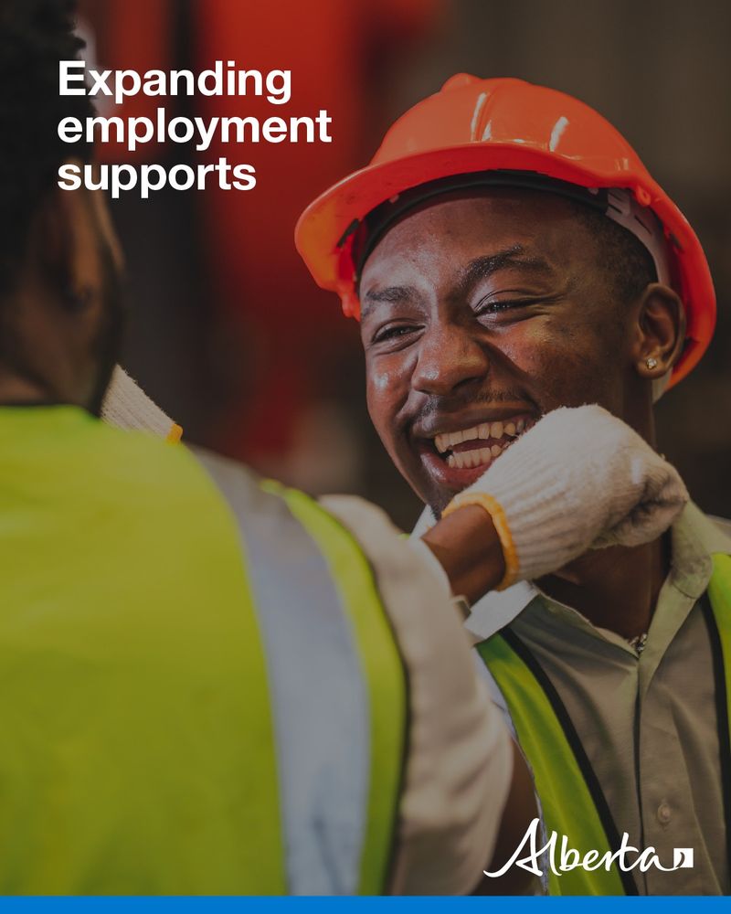 Two people in personal protective equipment smiling. Text reads Expanding employment supports. The Alberta government logo is in the bottom right. 