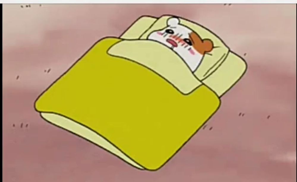 a cartoon hamster is laying in a bed with a yellow comforter