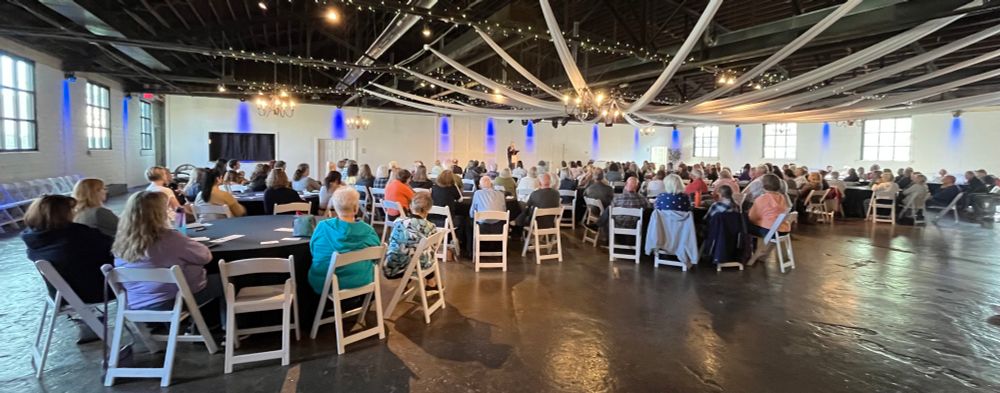 A large gathering of people in an event center in Liberty, Missouri. 