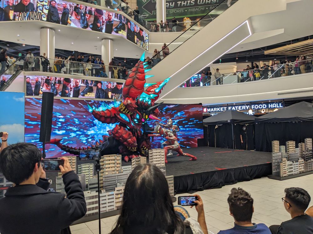 Ultraman, Ultraman Zero, and Ultraman Omega deliver a finishing blow to a colossal Belial fusion monster as part of Ultraman Live at American Dream Mall.