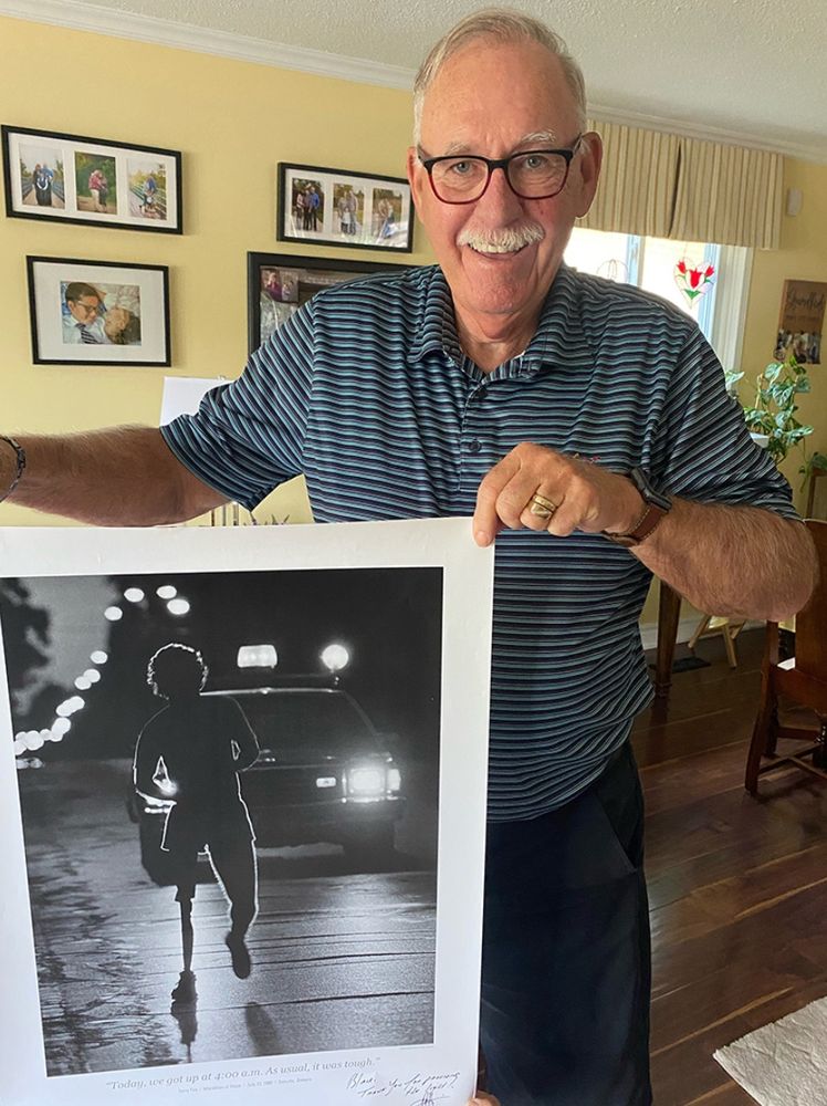 Blair Vintinner, the driver of the police car behind Terry Fox holding the iconic black and white photograph as they entered Oakville early in the morning in July, 1980 by Pete Martin. 