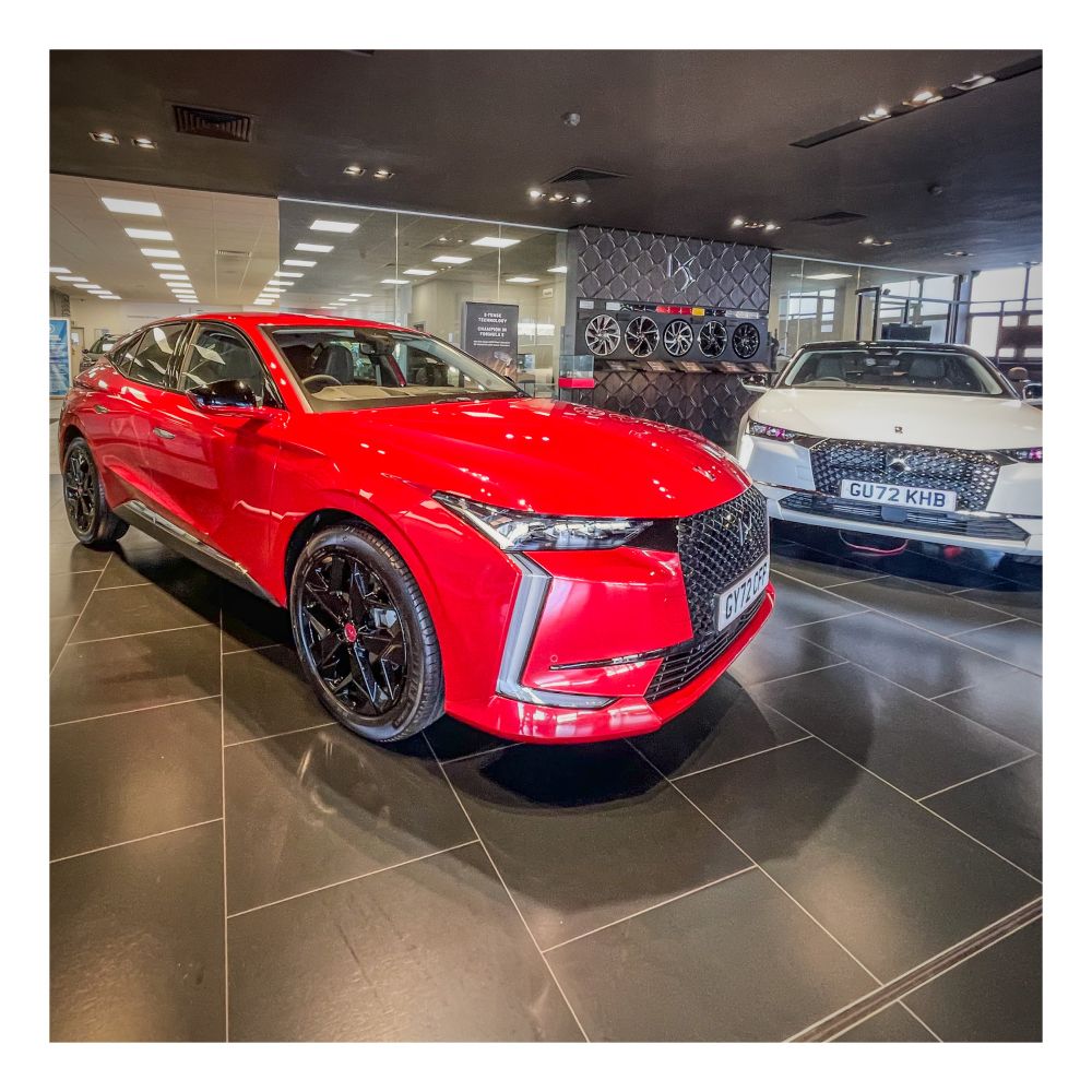 Red car in showroom.
