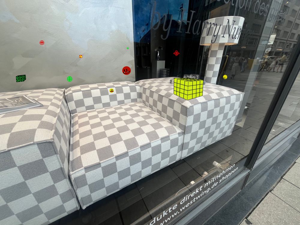 The same photo as the original post, containing the checkerboard-pattern furniture, but edited to look as if it was a screenshot from the game Fractal Block World. It contains various enemies and other game elements added onto the image.