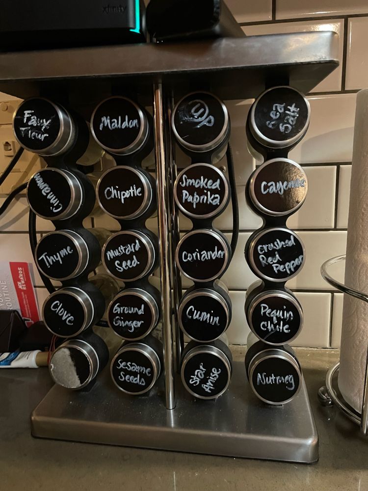 Spice rack of most used spices, standard countertop rack with twenty containers. Includes four types of salt, and the chalkboard marker label in which my partner discovered that rubbing alcohol and chalkboard labels don’t mix.