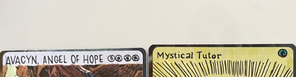 The tops of two hand drawn proxy cards: Avacyn Angel of Hope and Mystical Tutor