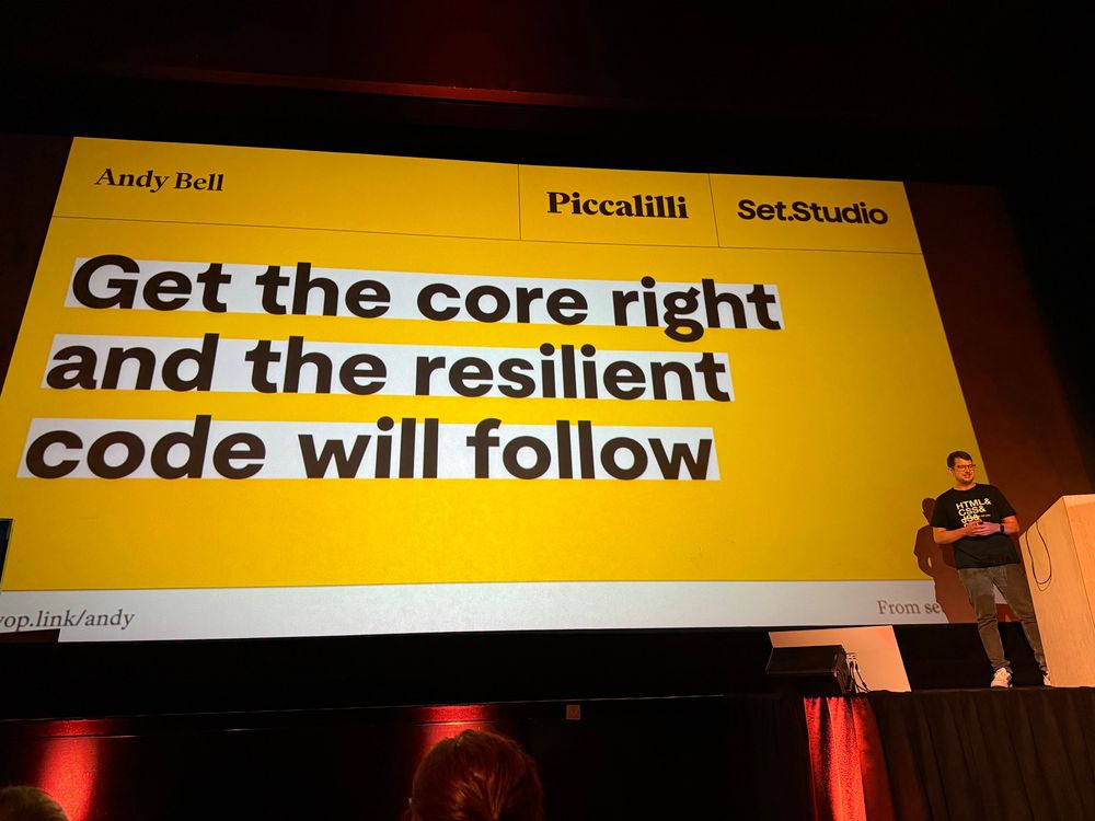 Andy Bell giving his talk at All Day Hey in front of a slide that reads “Get the core right and the resilient code will follow”