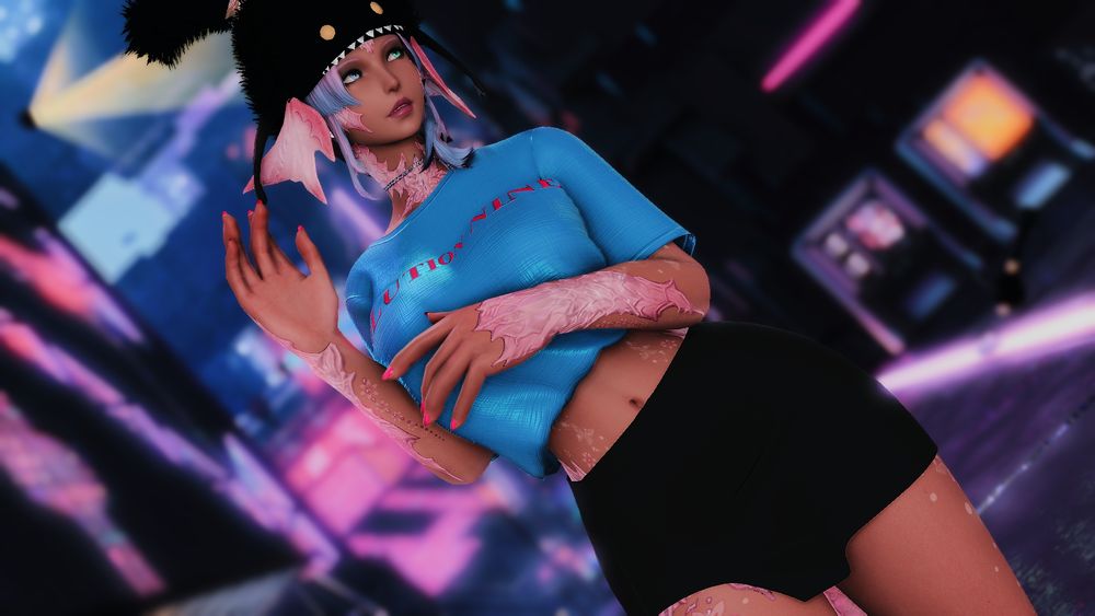Sylari standing in front of a wall in Solution 9, wearing a blue loose, shirt that leaves her belly exposed, and a short skirt. 