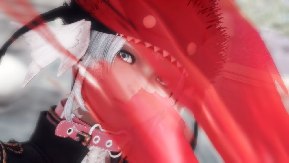 upclose shot of Sylari's face with a streak of red pant in front of it