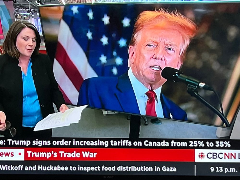 A picture of Trump where his hair is orange and doesn’t seem to make any sense. It kind of looks like it is blowing off? I guess? 