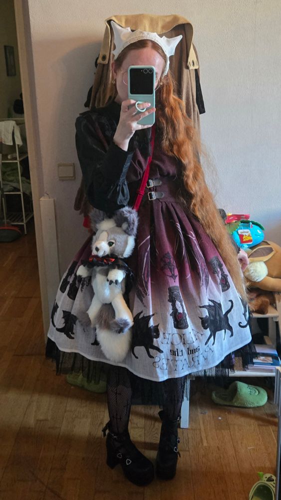 Mirror selfie while wearing a white bat/cat ear Antique BeasT headdress, Devil Cat and the Hourglass of Ending OP in the wine colourway, and Captain Chris Jade pochette from Alice and the Pirates. Black fishnets with cross motives and Angelic Imprint platform heels with heart buckles and bows on the back.