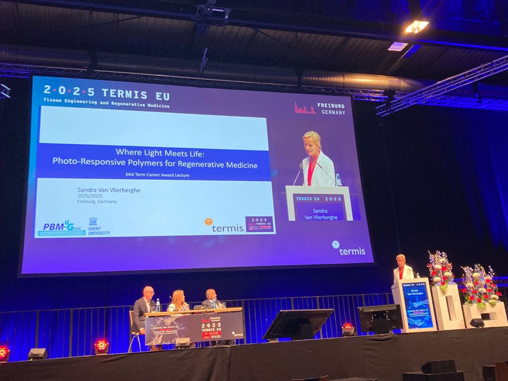 Picture of Sandra van Vlierberghe on a podium next to her slide. 