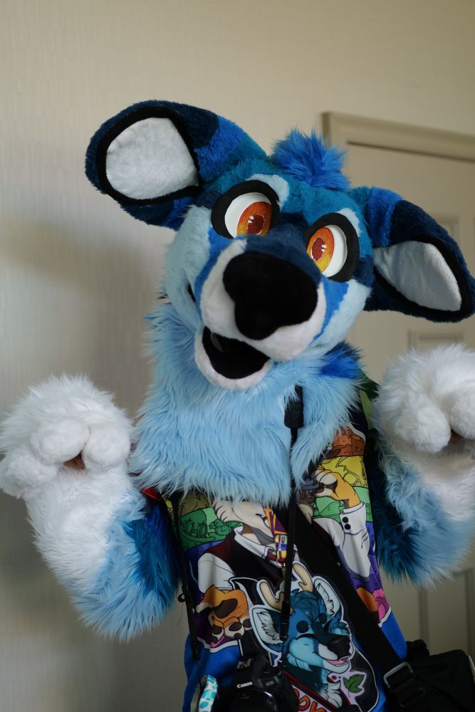 A blue deer fursuiter posing for a picture.