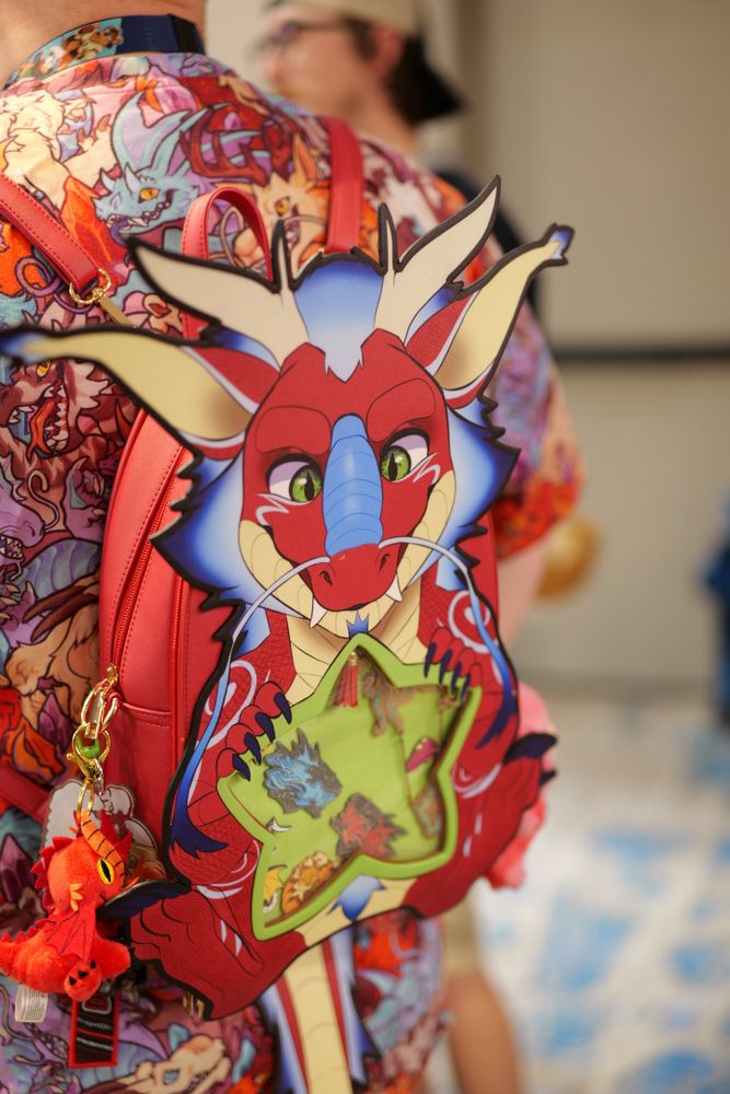 A colorful dragon backpack being worn at the chomp market event.