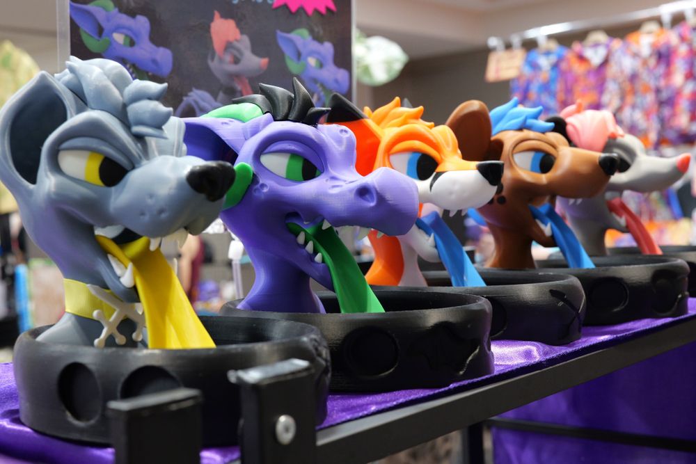 An assortment of dice towers made to look like furry characters.