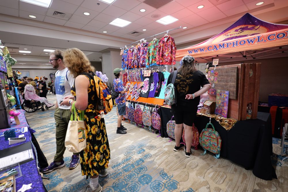 People shopping at the colorful market space of the chomp event.