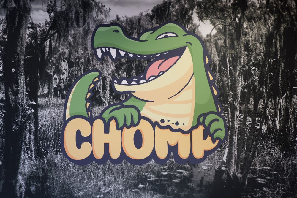 Banner artwork of a cartoon alligator displayed at the Chomp event.