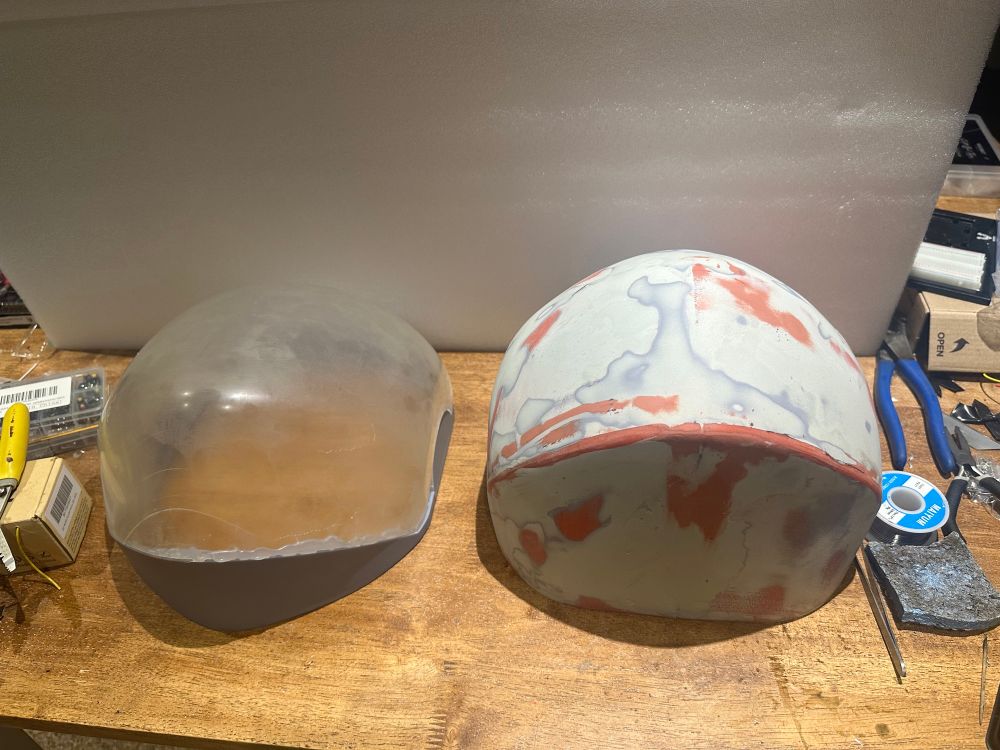 Two objects next to each other; both 3D printed “visor bucks” is what I call them. Showcasing a step of how I make my helmets. 