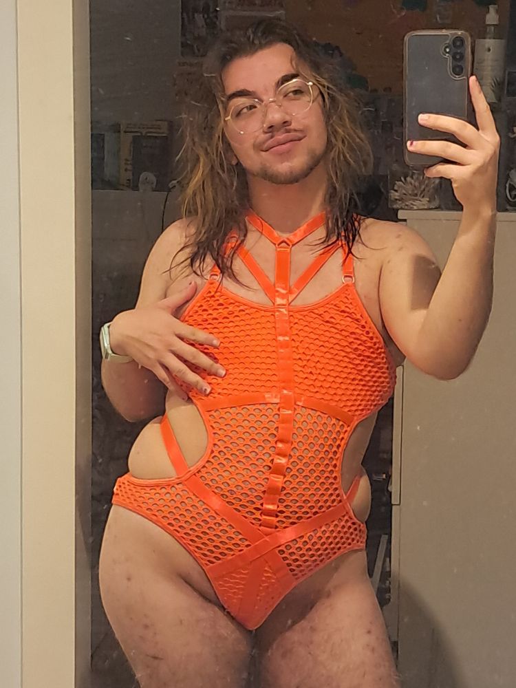 Mirror selfie of me in a neon orange one-piece lingerie.