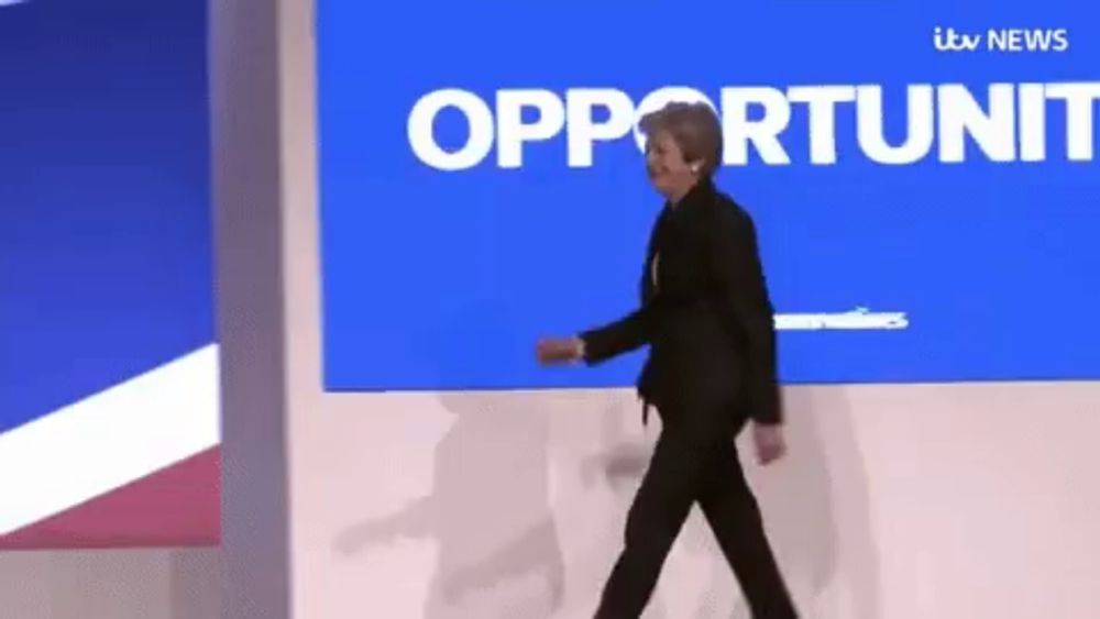 a woman is walking in front of a blue screen that says opportunity