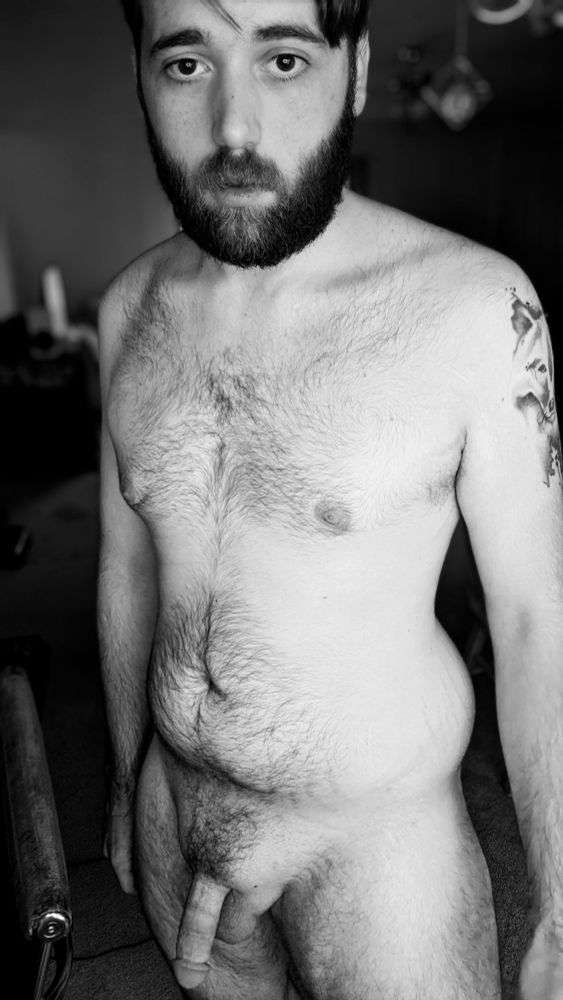 Chris standing nude in black and white